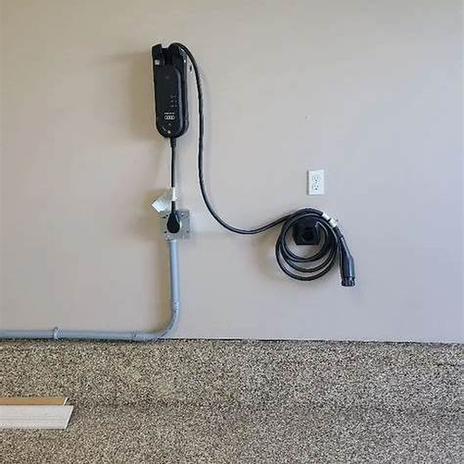 Free stock photo of a wall mounted EV charger in a tidy garage space